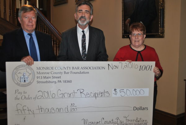 (from left) William Reaser joins $50,000 grant recipient Tim Lee of Pocono Services for Families and Children Monroe County Head Start with fellow Monroe County Bar Foundation member Diane Dagger