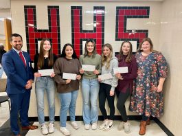 Steve Daniels and Kristen Lancia present smiling Honesdale High School finalists with $100 gift cards.